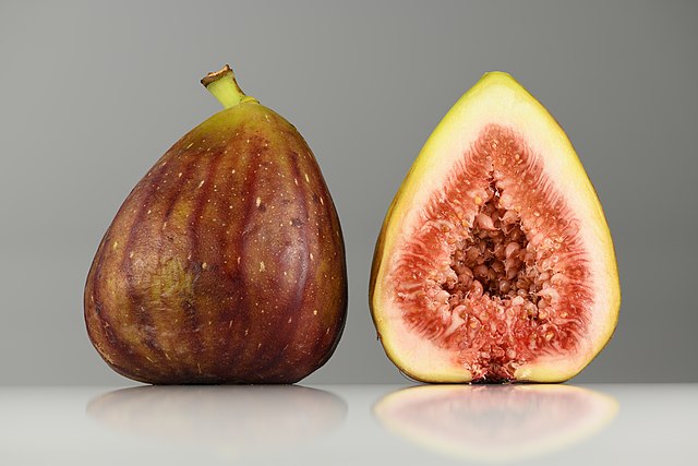 A ripe fig and a ripe fig cut in two